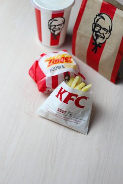 Bangkok, Thailand - January, 10 2023 : KFC Chicken Burger or Singer Burger served with soft drinks and french fries, KFC is a popular fast food in Thailand.
