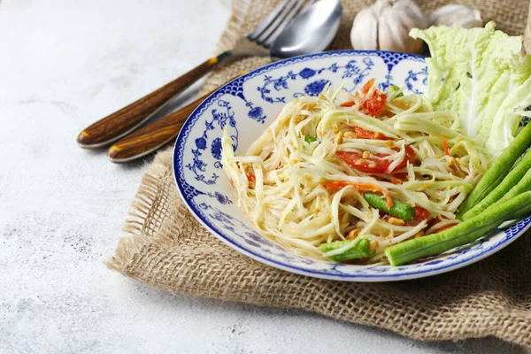 stock image Somtum, Thai spicy papaya salad on white background, international Thai food Known and popular, made with papaya and tomatoes, it tastes sour, sweet and spicy.