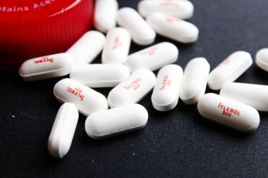 Bangkok, Tayland - 10 Ekim 2023 - Siyah arka plana yerleştirilmiş Tylenol hapları, Tylenol hapları, ağrı kesiciler, ateş hapları, Amerika 'da ağrı kesici