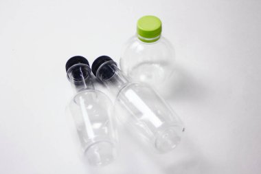 Beyaz arka planda plastik su şişeleri. Su içmek için plastik şişeler.