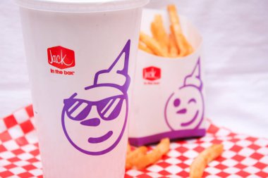 WASHINGTON, ABD - Temmuz 07 2024: Jack in the box, French fries and glass serve on a brown wood table.