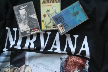 Resimde siyah Nirvana tişörtüne yerleştirilmiş üç Nirvana kaseti - 