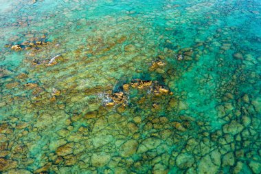 Bu manzara fotoğrafı Avrupa 'da, Yunanistan' da, Girit 'te, Elafonisi' de, Akdeniz kıyısında, yazın çekildi. Güneşin altında kayalık sahili ve kurak dağlarını görüyoruz..