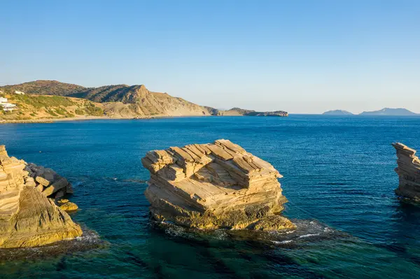 This landscape photo was taken, in Europe, in Greece, in Crete, towards Rethymno, At the edge of the Mediterranean Sea, in summer. We see the rocks of Triopetra Beach, under the sun.