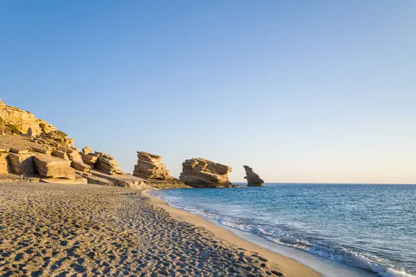 This landscape photo was taken, in Europe, in Greece, in Crete, towards Rethymno, At the edge of the Mediterranean Sea, in summer. We see the rocks on the edge of Triopetra Beach, under the sun.
