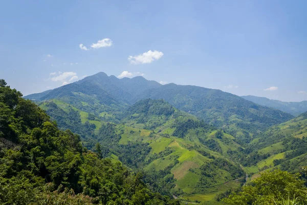 stock image This landscape photo was taken, in Asia, in Vietnam, in Tonkin, between Dien Bien Phu and Lai Chau, in summer. We see the forests above the green mountains, under the Sun.