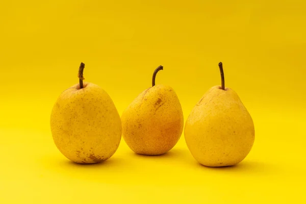 Yellow pears on a yellow background