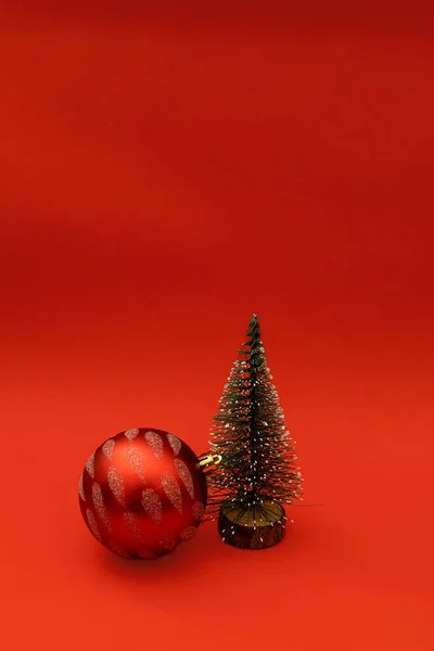 Christmas tree in the form of a red ball on a red background, monochrome