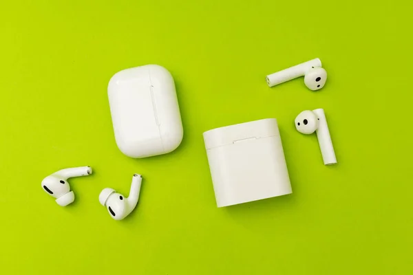 Küçük bir kutuda beyaz kulaklıklar, akıllı aygıt