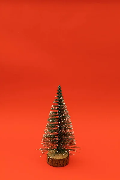 stock image A small Christmas tree on a red holiday background