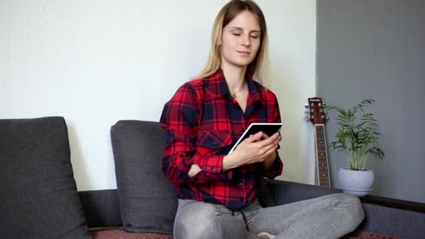 Girl Cradles Her Tablet Looks Away — Stock Video