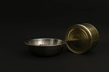 Canned food in a tin on a black background