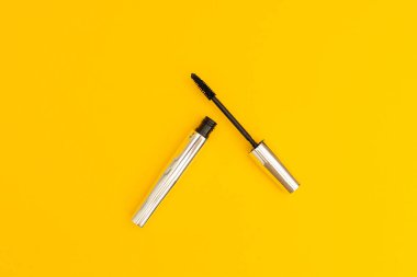 Mascara in silver package with yellow background