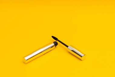 Mascara in silver package with yellow background