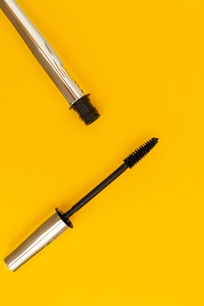 Mascara in silver package with yellow background