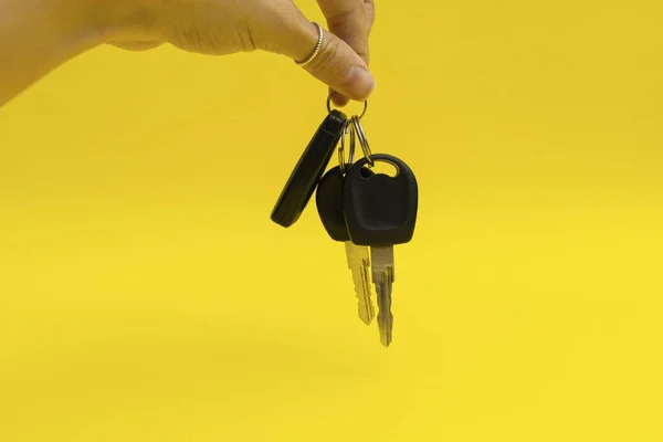 Car keys on yellow background
