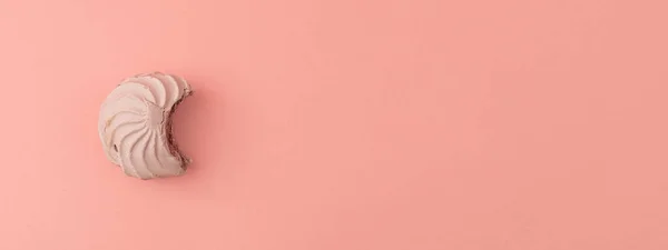 Pink marshmallow banner on a pink background. Minimalism and monochrome