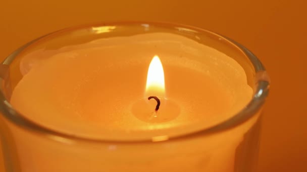 Candle Burning Orange Background Macro Shot Good Quality — Stock Video