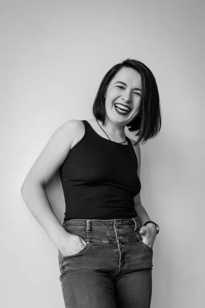 Girl with short haircut laughing, black and white photo
