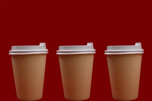 Paper cup with white lid on red background, collage