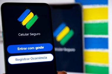 Aplicativo Celular Seguro com fundo desfocado ve core do Brasil.