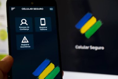 Aplicativo Celular Seguro com fundo desfocado ve core do Brasil.