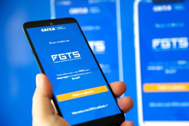 Bir cep telefonu ekranında mavi arkaplan ile Caixa fgts uygulaması.