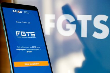 Bir cep telefonu ekranında mavi arkaplan ile Caixa fgts uygulaması.