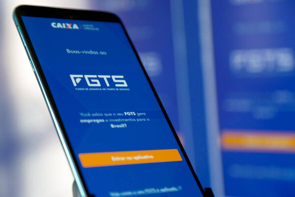 Caixa fgts application with blue background on a cell phone screen.