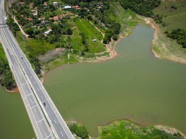 Barajın ve otobanın üstünden yüksek köprüler ve güzel mavi gökyüzü ile çevrili doğa manzarası.