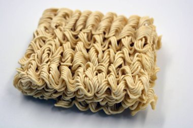 Quick cooking product, food, vermicelli, thin noodles in dry form is located on a white background.