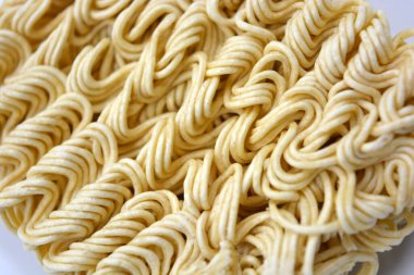 Quick cooking product, food, vermicelli, thin noodles in dry form is located on a white background.