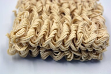 Quick cooking product, food, vermicelli, thin noodles in dry form is located on a white background.