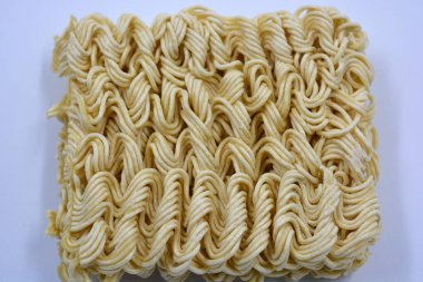 Quick cooking product, food, vermicelli, thin noodles in dry form is located on a white background.
