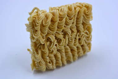 Quick cooking product, food, vermicelli, thin noodles in dry form is located on a white background.