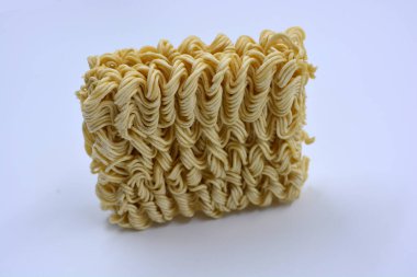 Quick cooking product, food, vermicelli, thin noodles in dry form is located on a white background.