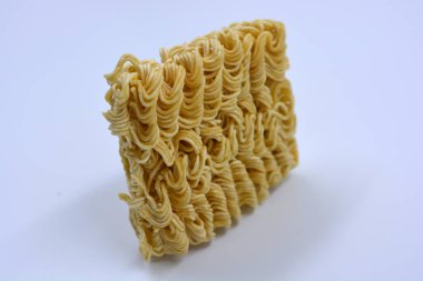 Quick cooking product, food, vermicelli, thin noodles in dry form is located on a white background.