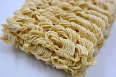 Quick cooking product, food, vermicelli, thin noodles in dry form is located on a white background.