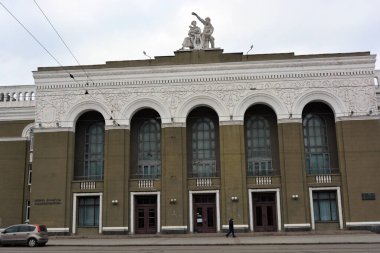 Winter photos of the big street Rabochaya in the city of Dnipro, ukraine. Wide road, parks, yards with cars, people, trees, Christmas trees, big houses and shops on a weekday.