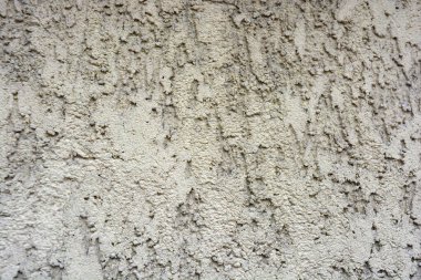 Building backgrounds, wall cladding made with brown textured and structural plaster in the form of bark on the wall of one of the houses in the city of Dnipro, Ukraine.