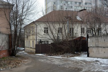 Quiet winter snowy streets, nooks and crannies of the street with houses, high fences in the city of Dnipro, ukraine.