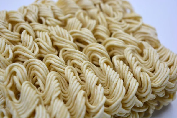 Quick cooking product, food, vermicelli, thin noodles in dry form is located on a white background.