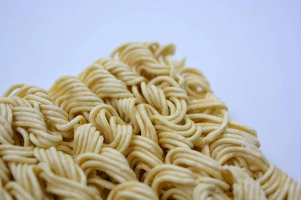 Quick cooking product, food, vermicelli, thin noodles in dry form is located on a white background.