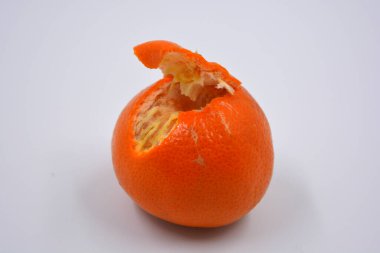 Ripe peeled orange tangerine, sweet fruit with orange skin located on a white background in different positions.