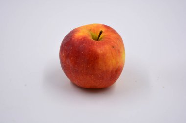 One ripe red yellow apple, a sweet fruit arranged on a white background.
