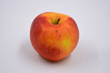 One ripe red yellow apple, a sweet fruit arranged on a white background.