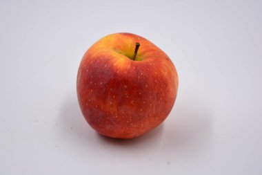 One ripe red yellow apple, a sweet fruit arranged on a white background.