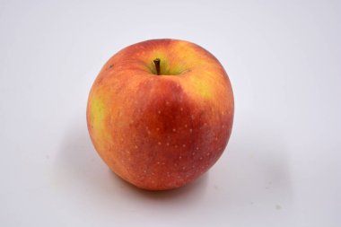 One ripe red yellow apple, a sweet fruit arranged on a white background.