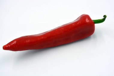 Parlak taze sebzeler, tatlı kırmızı biber, parlak kırmızı büyük biber beyaz arka planda yer alır.. 