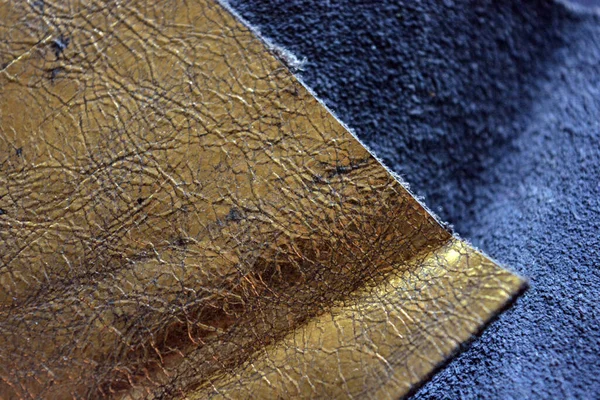 Beautiful materials, leather goods, a natural thick piece of leather with a golden sheen, shimmer and gilding, wrinkled leather.
